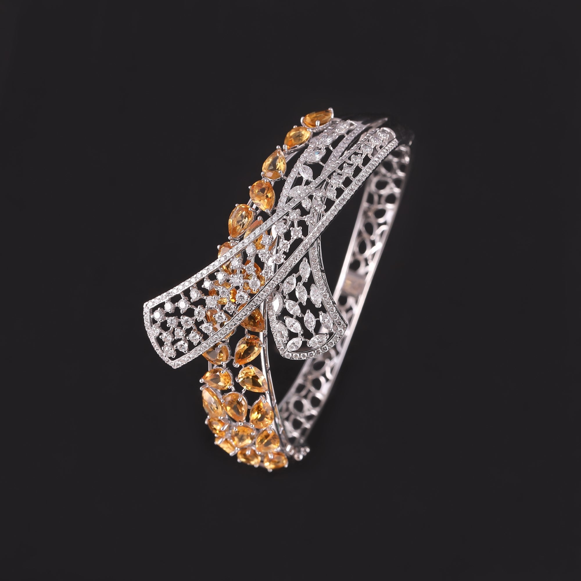 Silver bracelet with orange gemstones on a black background