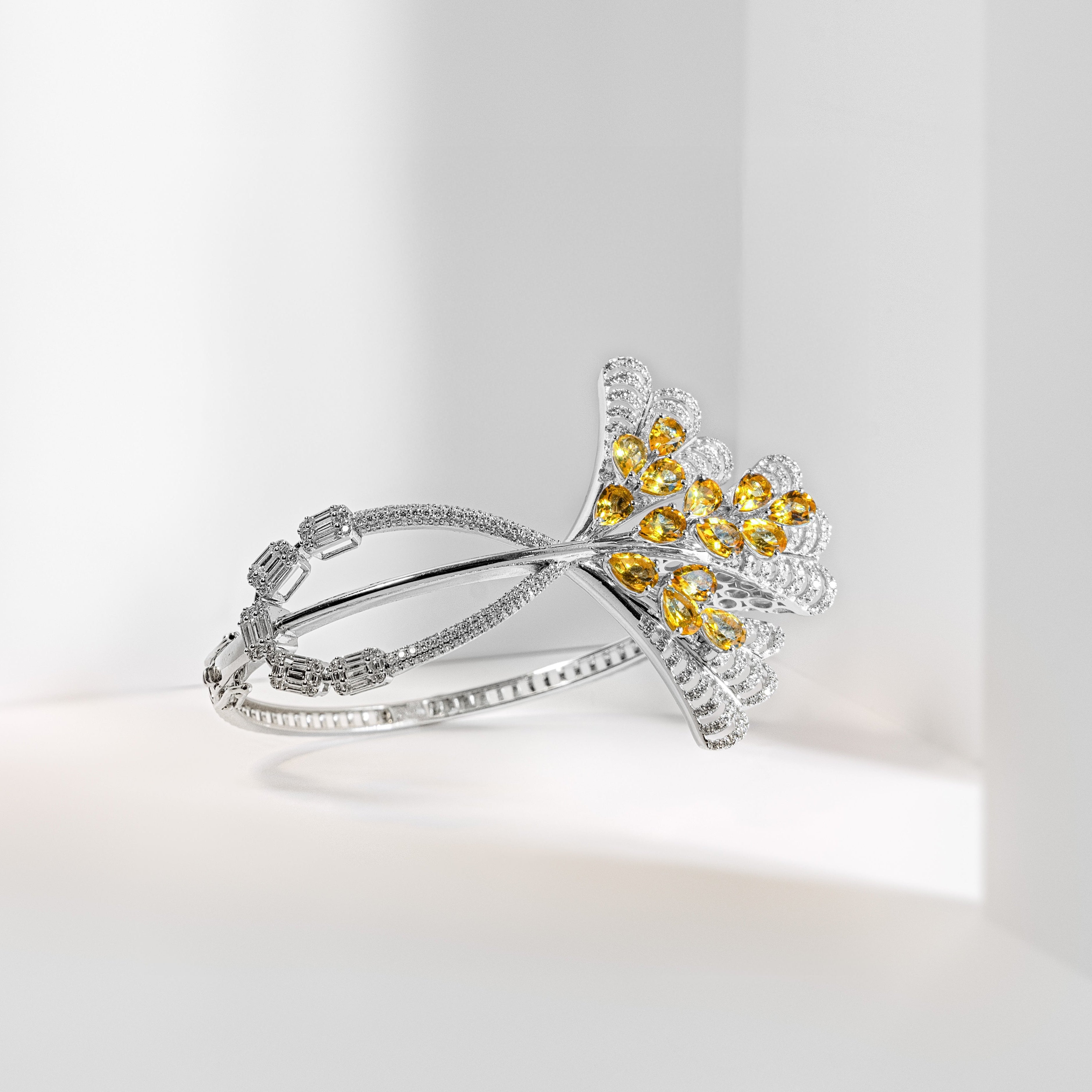 A silver-toned Art Deco style ring featuring a floral motif with yellow gemstones and clear pavé accents, displayed on a clean white background.