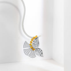A silver butterfly pendant necklace with yellow gemstone accents, suspended on a white cord against a clean white background.
