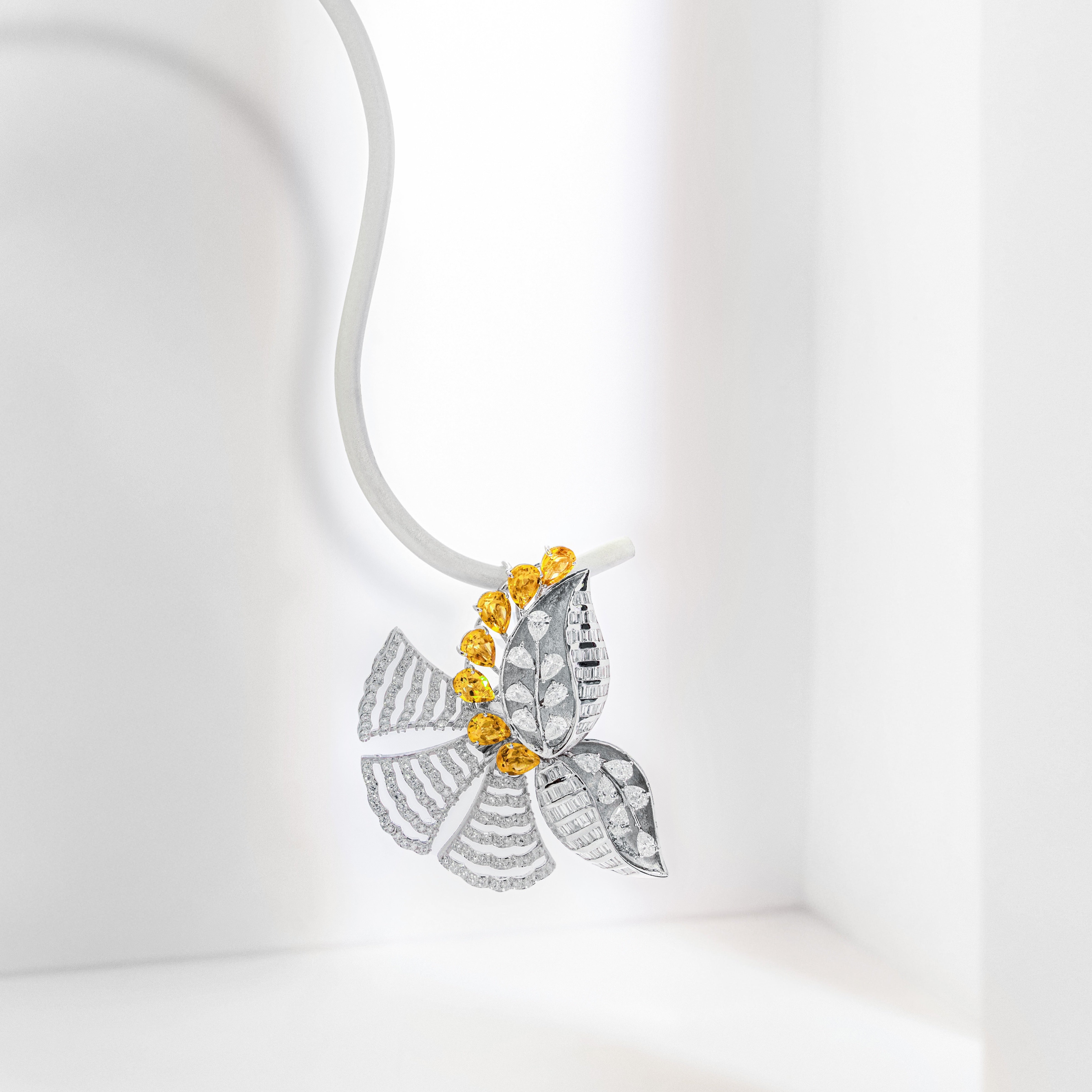 A silver butterfly pendant necklace with yellow gemstone accents, suspended on a white cord against a clean white background.