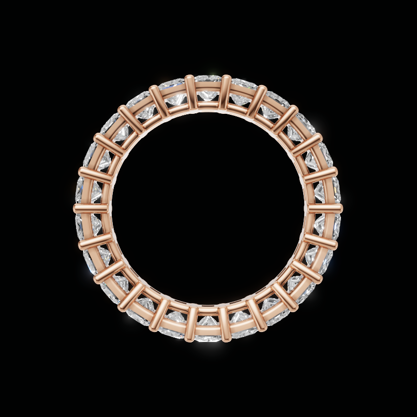 A circular rose gold ring featuring a continuous border of clear rectangular gemstones, presented on a solid black background.