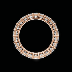 A circular rose gold ring featuring a continuous border of clear rectangular gemstones, presented on a solid black background.