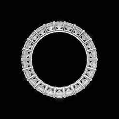 A silver-toned eternity ring featuring a continuous row of square-cut clear gemstones set in a circular shape, presented on a solid black background.