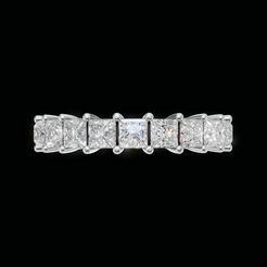 A diamond eternity ring featuring a row of princess-cut diamonds set in a silver-colored band, centered against a solid black background.