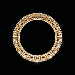 A gold circular ring featuring a geometric pattern of small clear gemstones, presented on a solid black background.