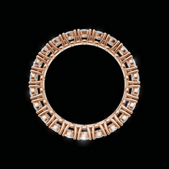 An oval ring in rose gold with a border of clear gemstones, shown against a solid black background.