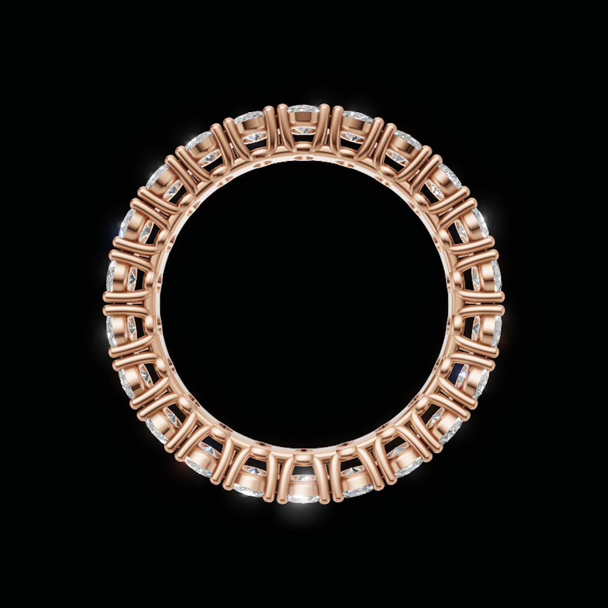 An oval ring in rose gold with a border of clear gemstones, shown against a solid black background.