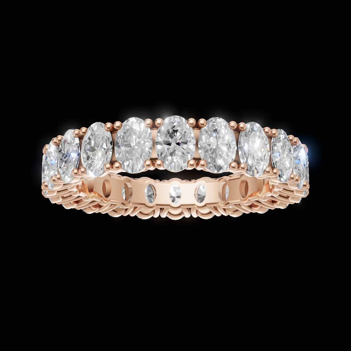 A rose gold eternity ring featuring a row of oval-cut clear diamonds set in a polished band, shown against a solid black background.