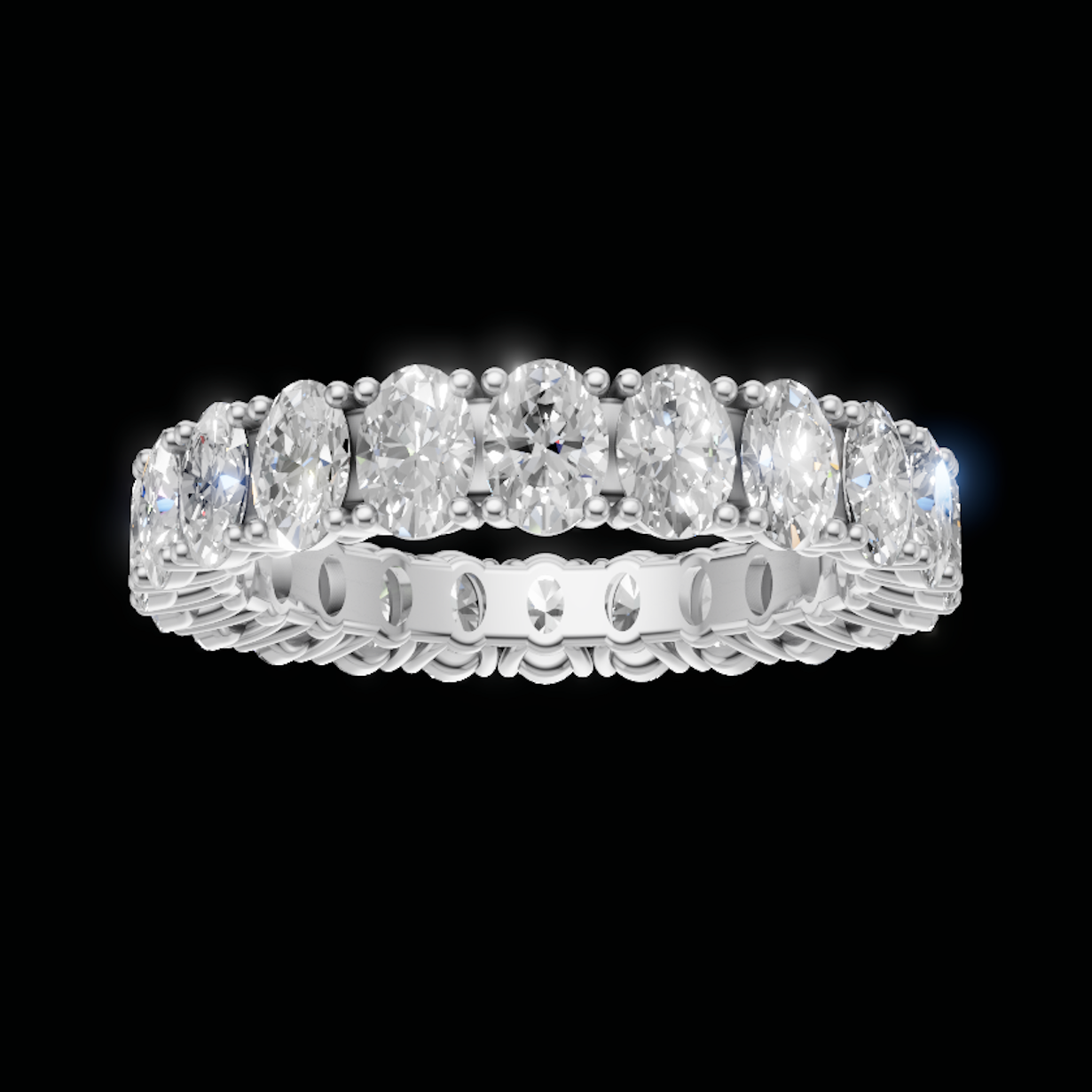 A silver-toned eternity ring featuring a row of oval-cut clear gemstones, shown against a solid black background.