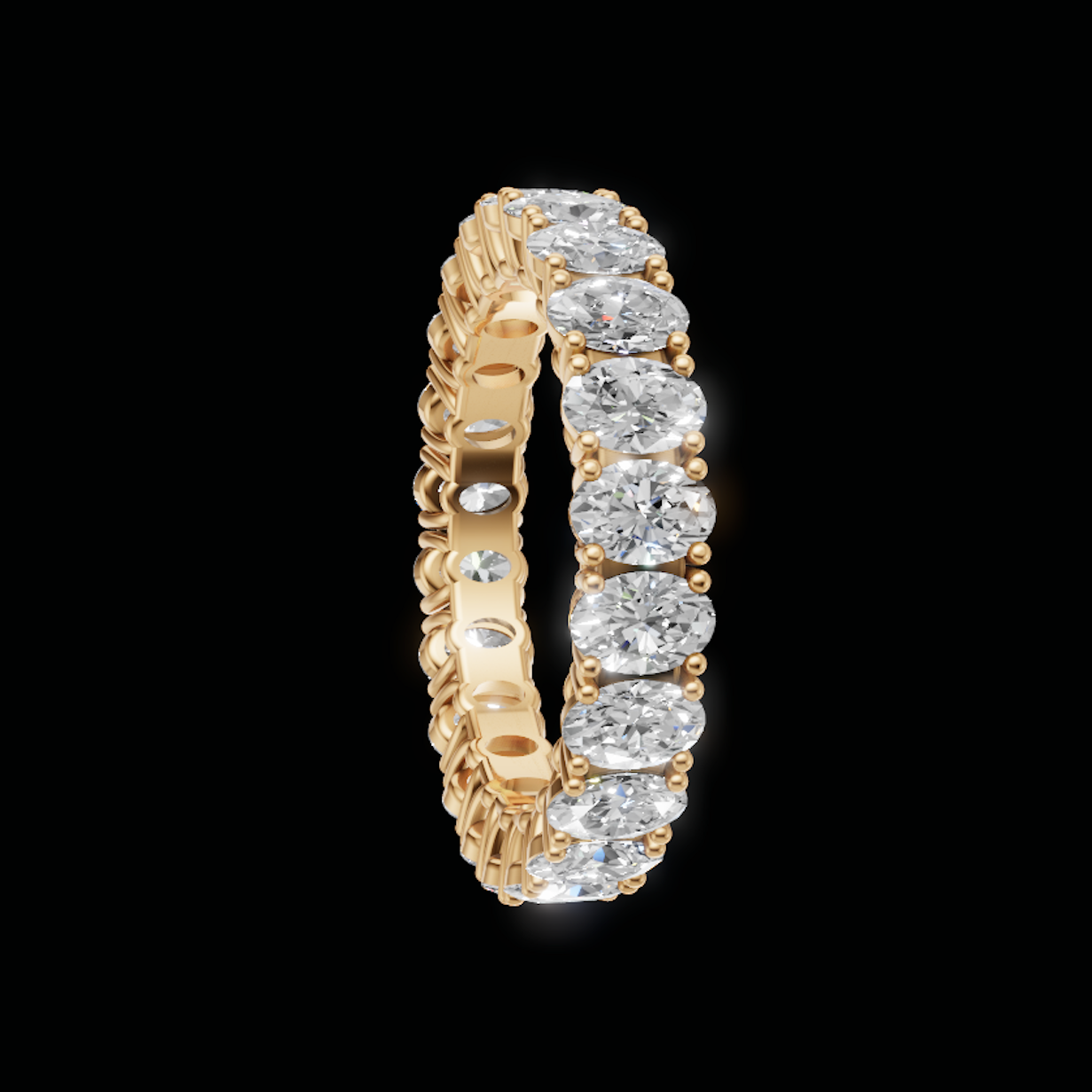 A yellow gold eternity ring featuring a continuous row of round brilliant-cut diamonds on a solid black background.